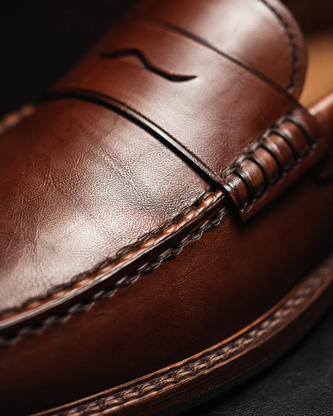 Macro detail of leather loafer stitching