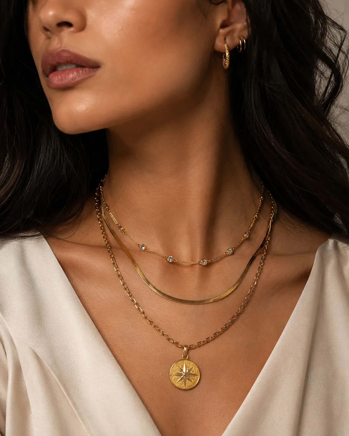 Model close-up with layered gold necklaces