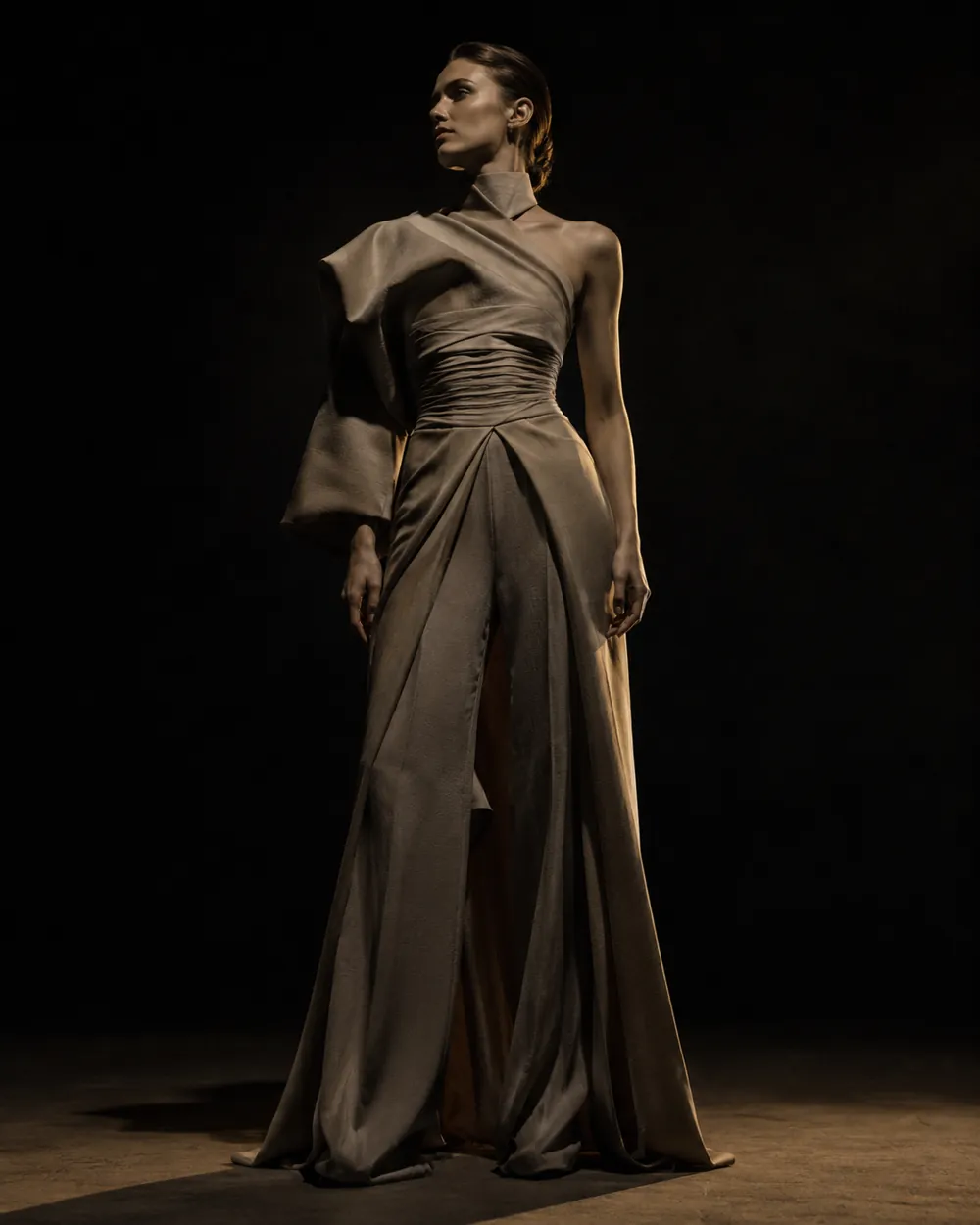 Sculptural editorial gown rendered in a dark studio — one consistent house signature